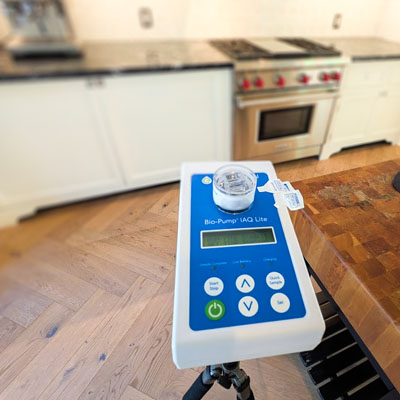Indoor Air Quality. Air mold sampling being performed in kitchen of modern home.